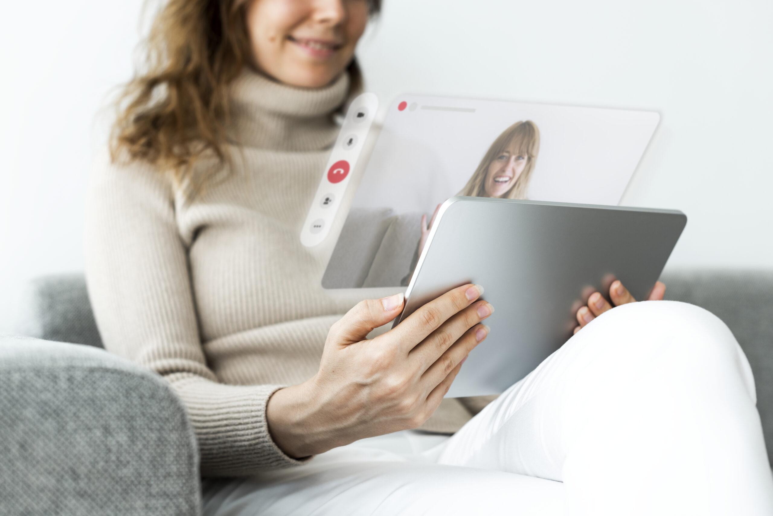 Woman using tablet for video call Therspy Session